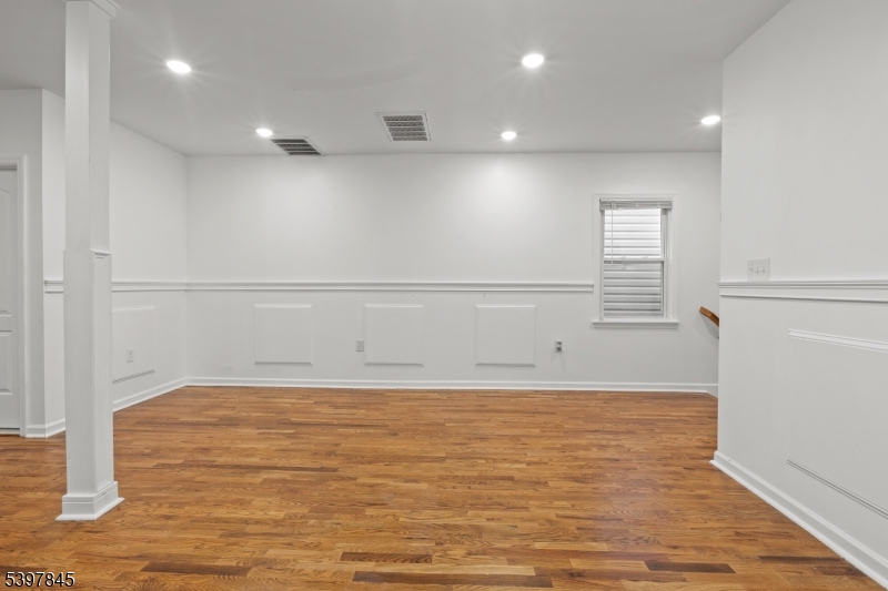 362 1/2 New Street, Unit 2 Newark, NJ 07103 - Photo 11 of 24 a view of an empty room with wooden floor and a window