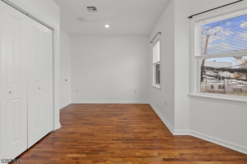 362 1/2 New Street, Unit 2 Newark, NJ 07103 - Photo 18 of 24 a view of an empty room with wooden floor and a window