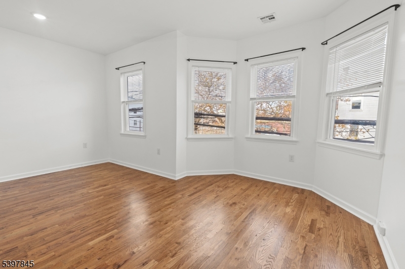 362 1/2 New Street, Unit 2 Newark, NJ 07103 - Photo 19 of 24 a view of empty room with wooden floor and fan