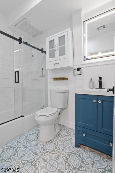 362 1/2 New Street, Unit 2 Newark, NJ 07103 - Photo 2 of 24 a bathroom with a toilet a sink a vanity and mirror