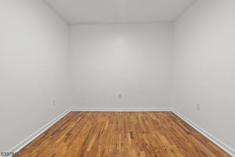 362 1/2 New Street, Unit 2 Newark, NJ 07103 - Photo 21 of 24 a view of room with wooden floor
