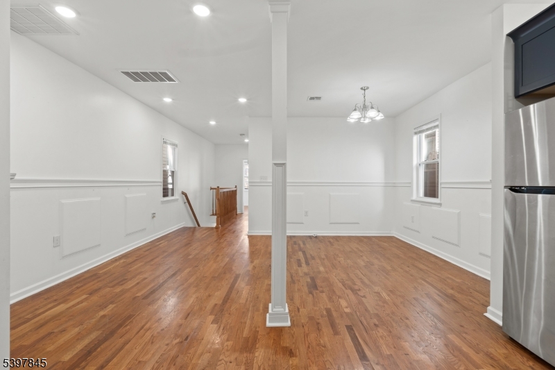 362 1/2 New Street, Unit 2 Newark, NJ 07103 - Photo 3 of 24 a view of empty room with wooden floor and fan