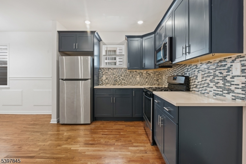 362 1/2 New Street, Unit 2 Newark, NJ 07103 - Photo 4 of 24 a kitchen with granite countertop stainless steel appliances a refrigerator and a sink