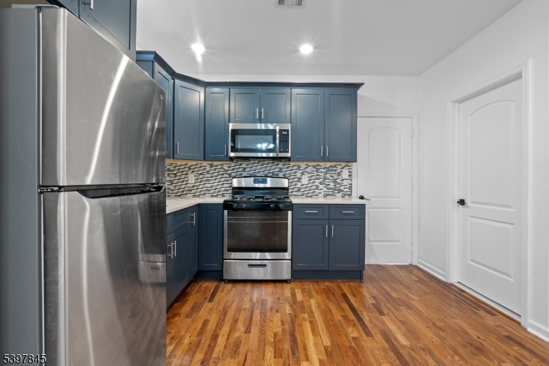362 1/2 New Street, Unit 2 Newark, NJ 07103 - Photo 6 of 24 a kitchen with a refrigerator and a stove top oven