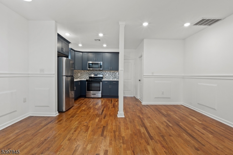 362 1/2 New Street, Unit 2 Newark, NJ 07103 - Photo 9 of 24 a view of kitchen with cabinets wooden floor and stainless steel appliances
