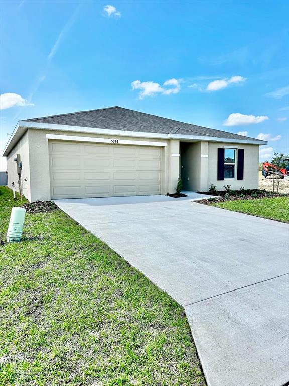 a view of a house with a yard and garage