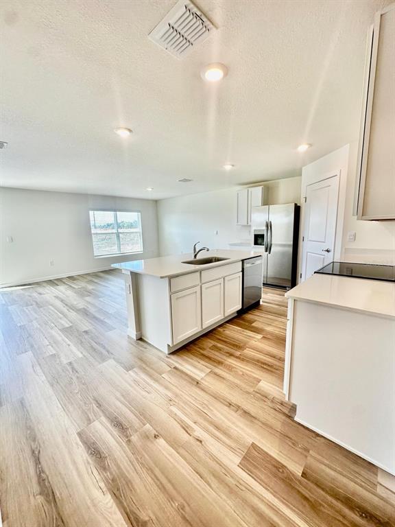 5844 Southwest 132nd Place Ocala, FL 34473 - Photo 4 of 21 a large kitchen with stainless steel appliances a large counter top and a stove