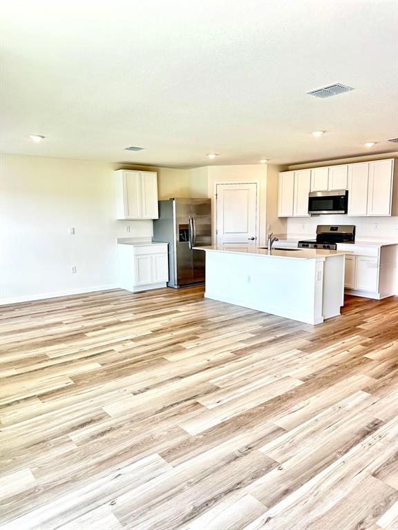 5844 Southwest 132nd Place Ocala, FL 34473 - Photo 5 of 21 a view of a kitchen with kitchen island a counter top space a sink stainless steel appliances and cabinets