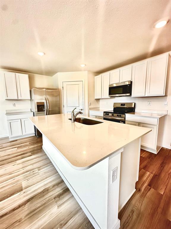 5844 Southwest 132nd Place Ocala, FL 34473 - Photo 6 of 21 a large white kitchen with wooden floor