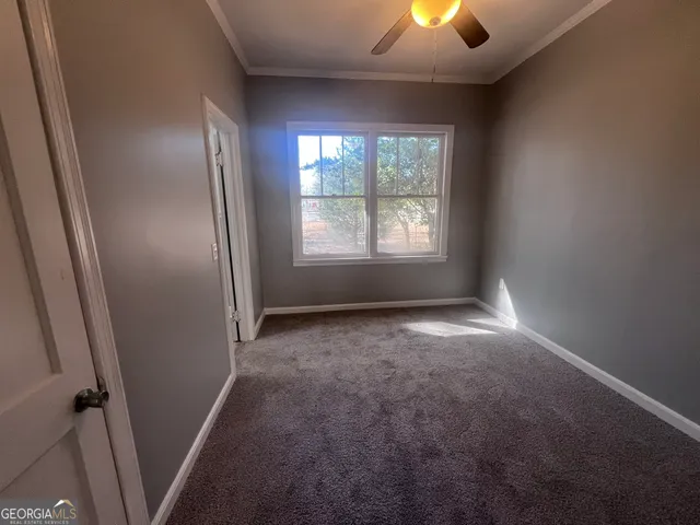 an empty room with yellow walls and window