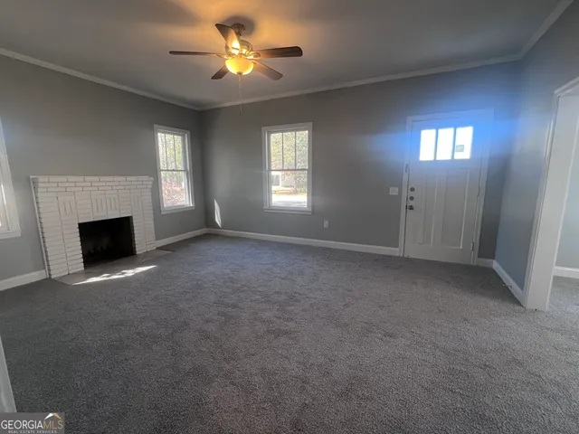 a view of empty room with window and fireplace