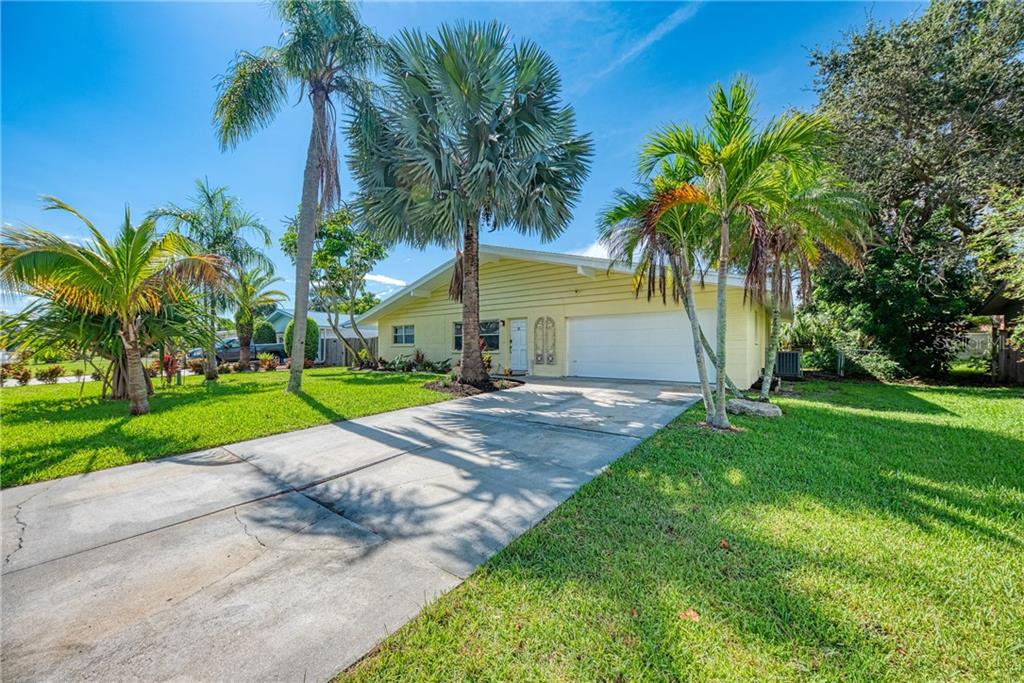 2434 Britannia Road Sarasota, FL 34231 - Photo 1 of 1 a view of a backyard with a garden and palm trees