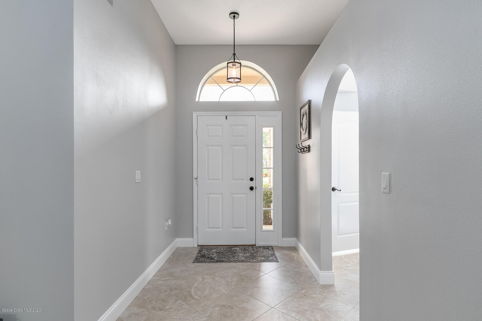3316 Slate Street West Melbourne, FL 32904 - Photo 4 of 35 an empty room with windows and ceiling fan