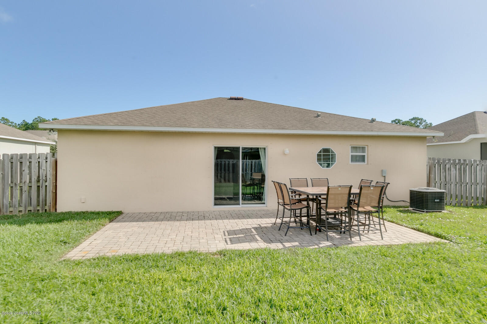 3316 Slate Street West Melbourne, FL 32904 - Photo 31 of 35 a patio with table and chairs and potted plants