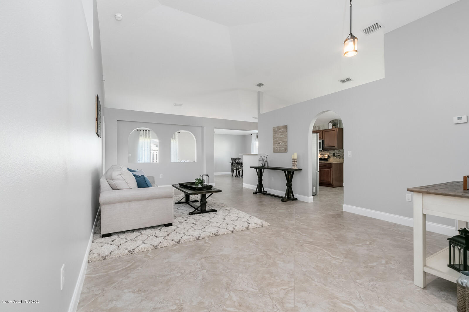 3316 Slate Street West Melbourne, FL 32904 - Photo 7 of 35 a living room with furniture and a chandelier