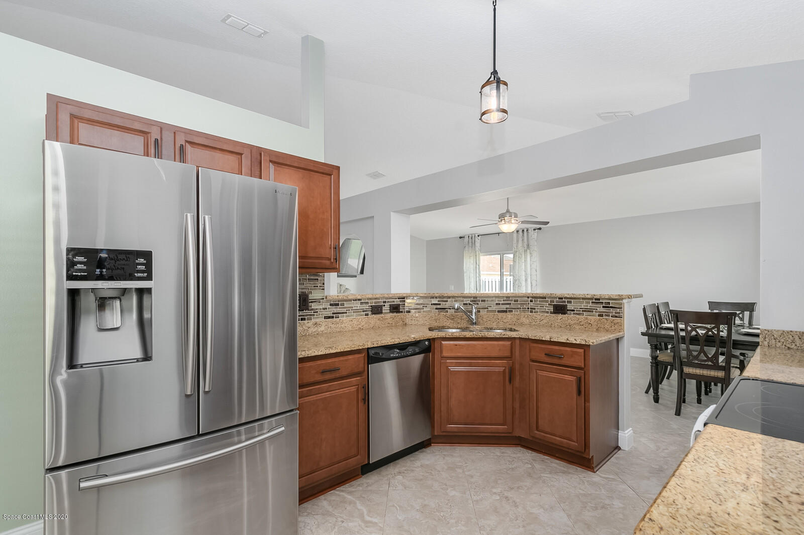 3316 Slate Street West Melbourne, FL 32904 - Photo 10 of 35 a kitchen with stainless steel appliances granite countertop a refrigerator a stove and a sink