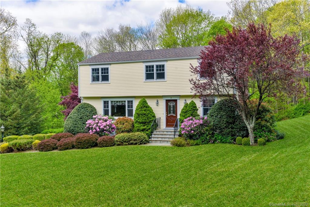 26 Cobblestone Place Wilton, CT 06897 - Photo 1 of 1 a front view of house with yard and green space