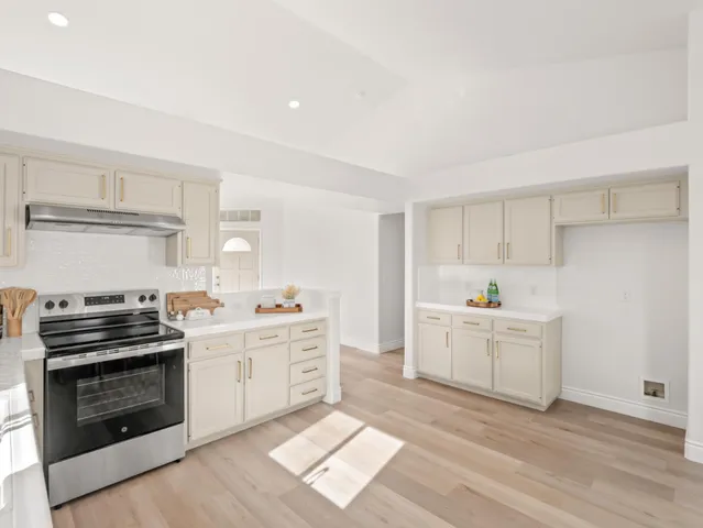 a kitchen with a stove oven and sink