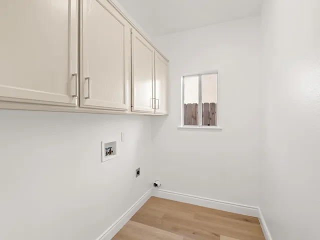 a view of small space with wooden floor and cabinet