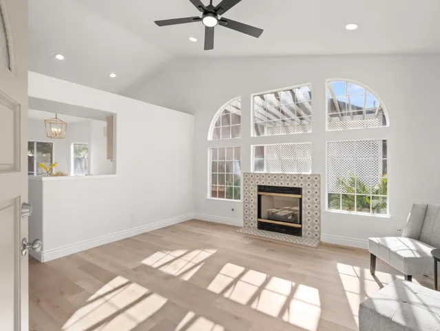 a view of an empty room with a window and fireplace