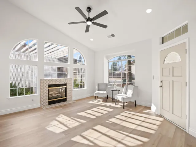 a living room with furniture a fireplace and a flat screen tv