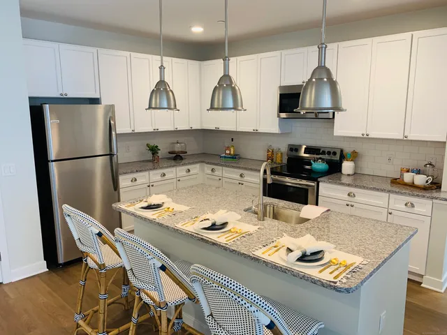 a kitchen with kitchen island a sink appliances and cabinets