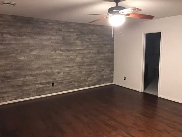 a view of a room with wooden floor