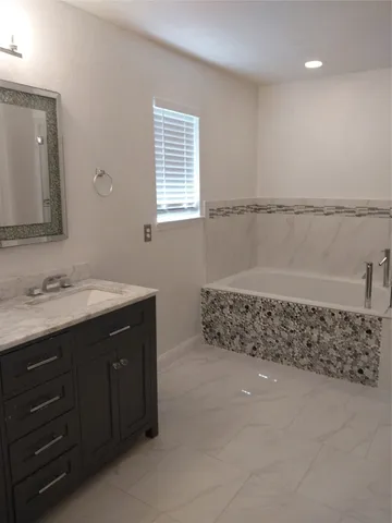 a bathroom with a double vanity sink and a window