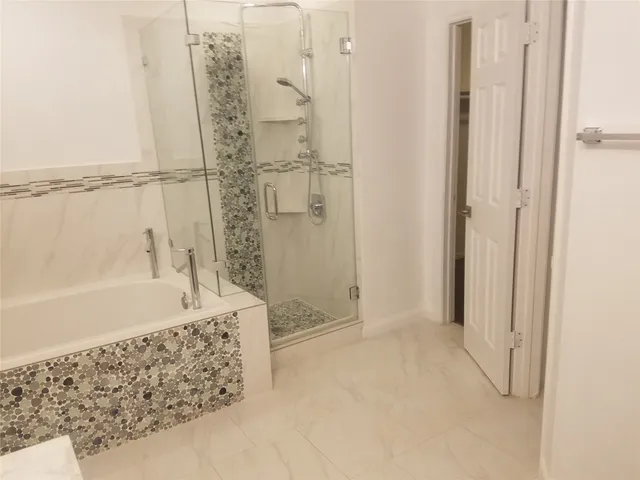 a bathroom with a bathtub and a shower