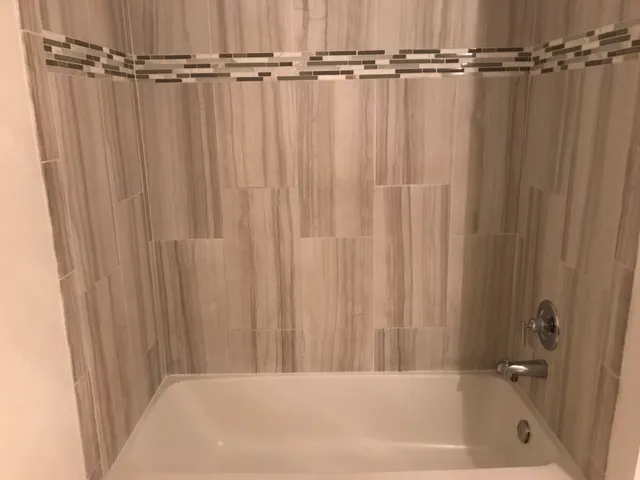 a bathroom with a bathtub and a shower