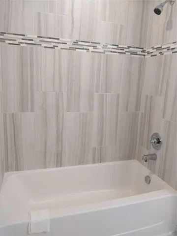 a bathroom with a shower a bathtub