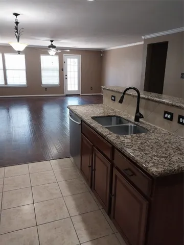 a kitchen with a sink a counter top space and cabinets