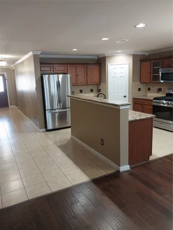 a kitchen with stainless steel appliances granite countertop a refrigerator stove and sink