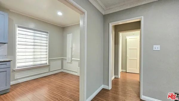 a view of a room with wooden floor and window