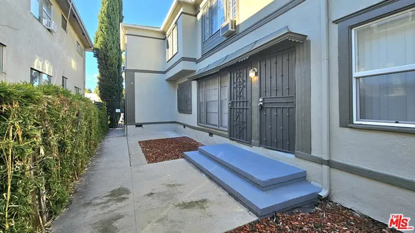 a view of a wooden bench with a bench in front of building
