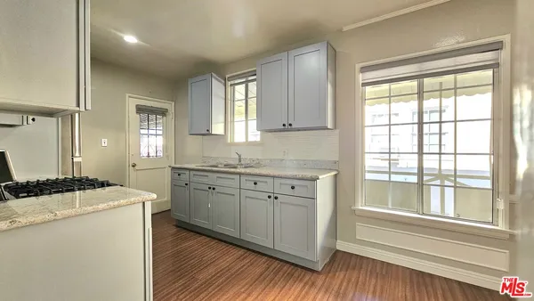 a kitchen with granite countertop cabinets a sink and appliances