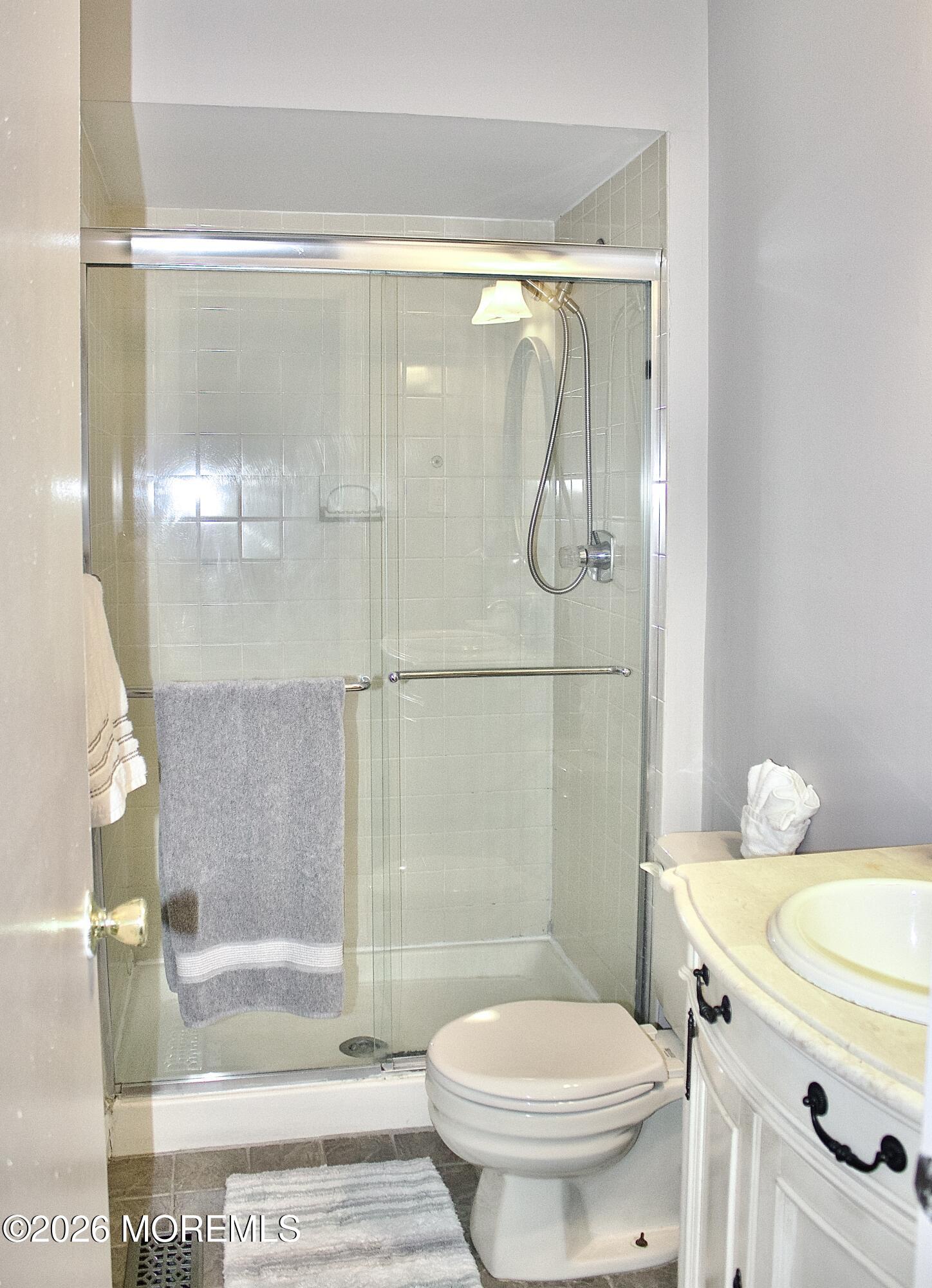 33 Balmoral Court Matawan, NJ 07747 - Photo 15 of 20 a bathroom with a shower a toilet and a sink