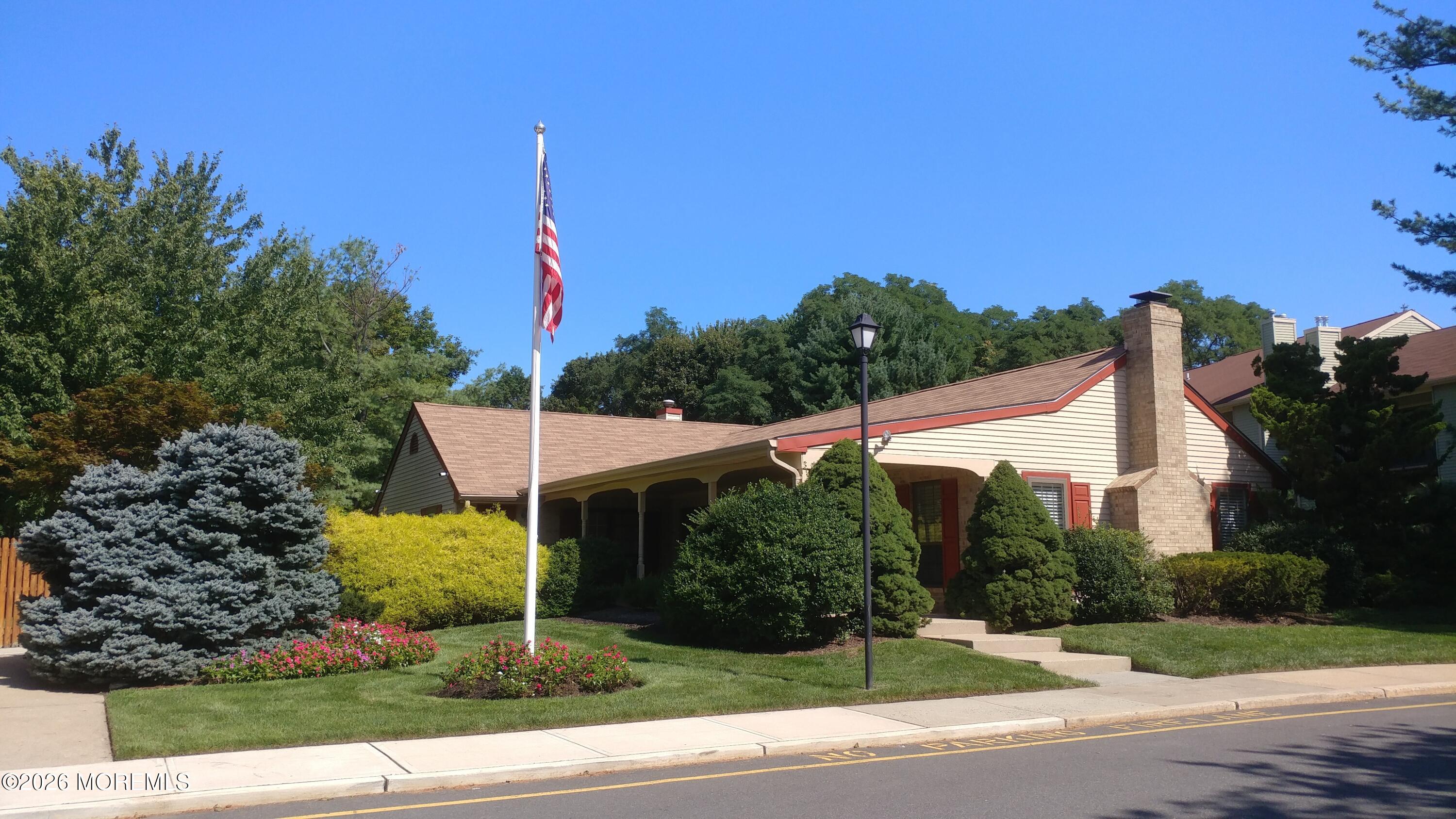 33 Balmoral Court Matawan, NJ 07747 - Photo 17 of 20 a view of a house with a yard and potted plants