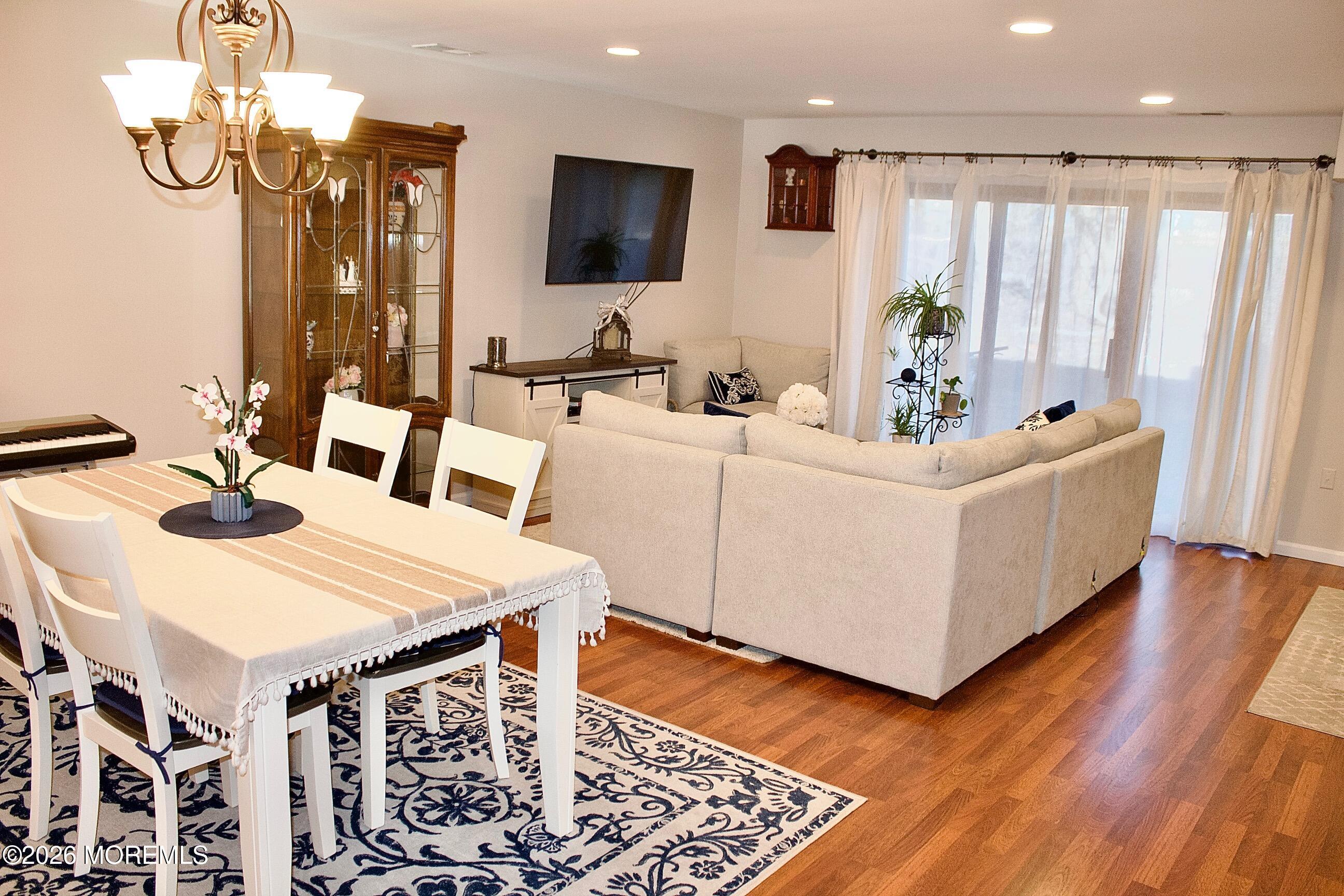33 Balmoral Court Matawan, NJ 07747 - Photo 8 of 20 a view of a dining room with furniture window and wooden floor