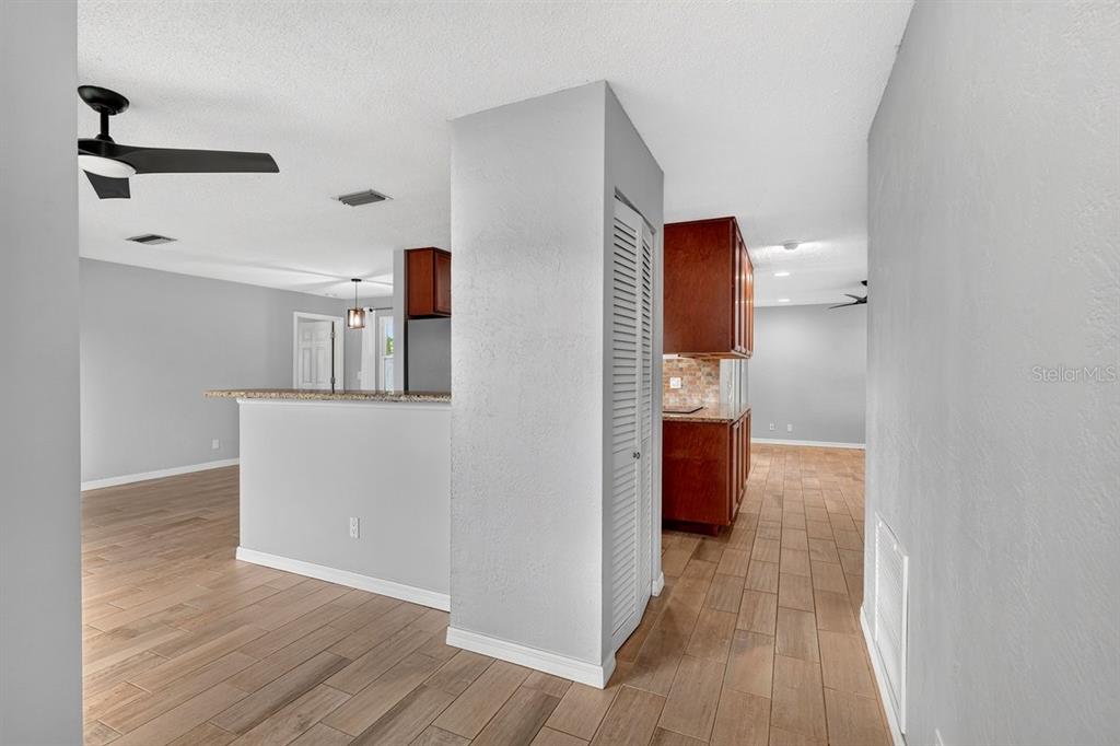 1309 Suwanee Road Daytona Beach, FL 32114 - Photo 3 of 33 a view of a hallway with wooden floor and cabinet
