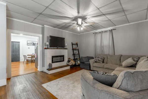 a kitchen with stainless steel appliances granite countertop a refrigerator a stove a sink a dining table and chairs