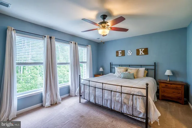 a bedroom with a bed and a large window