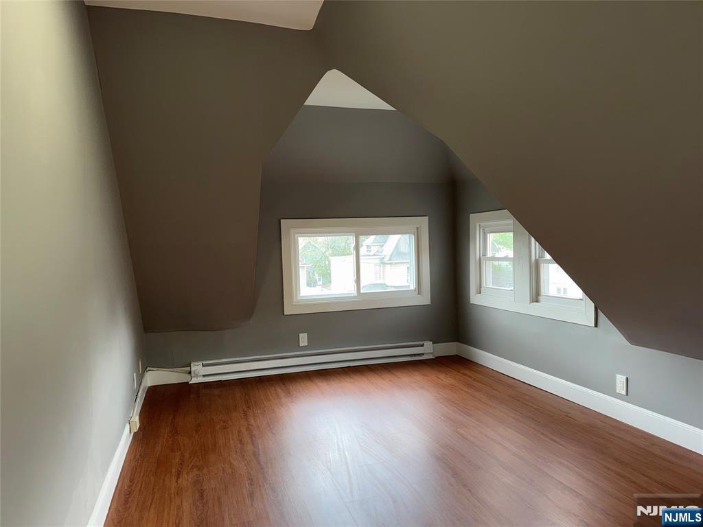 178 Berry Street Hackensack, NJ 07601 - Photo 16 of 22 an empty room with wooden floor and windows