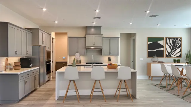 a large kitchen with a table and chairs