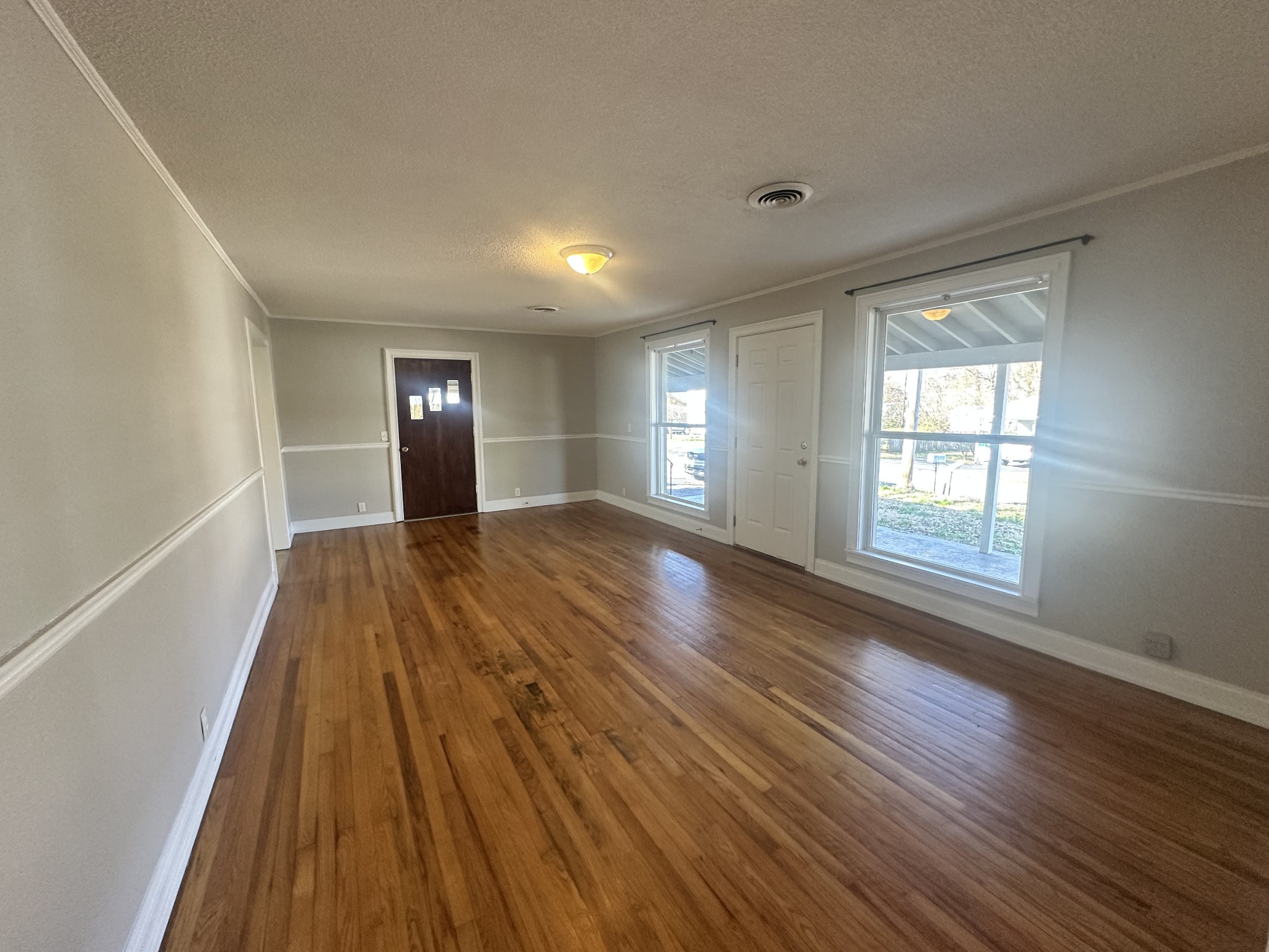 204 Ruby Street Winchester, TN 37398 - Photo 5 of 14 a view of wooden floor and windows in a room