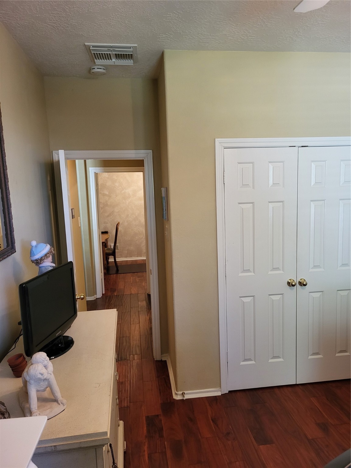 20226 Entrada Court Humble, TX 77346 - Photo 25 of 29 Currently bedroom three is loaded with furniture however this room has ample closet space and a reminder the wood floors are throughout the home except the two baths and laundry rm.