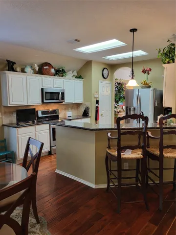 a room with furniture and wooden floor
