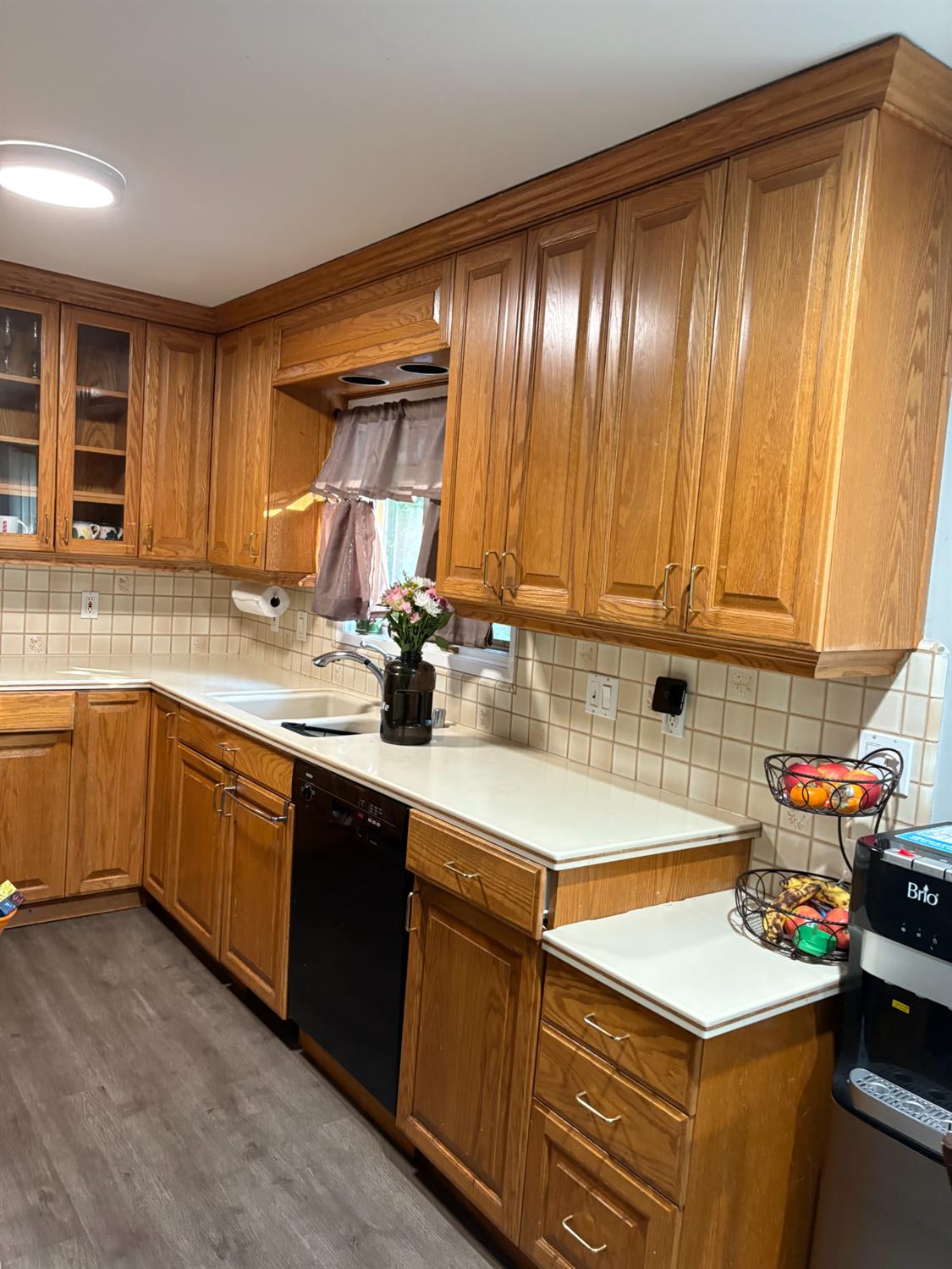 8415 Winding Way Fair Oaks, CA 95628 - Photo 13 of 27 a kitchen with a sink stove and cabinets