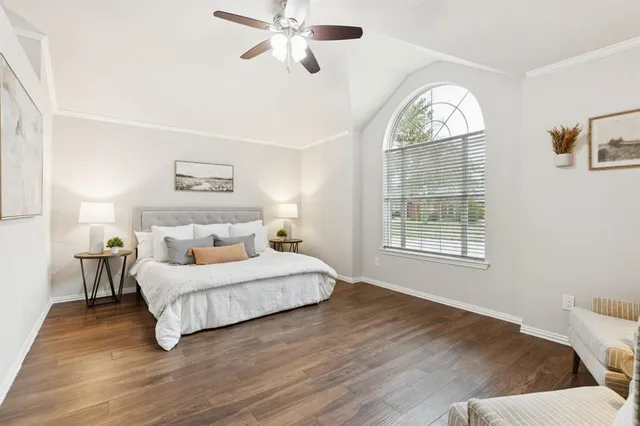 a bedroom with a large bed and a window