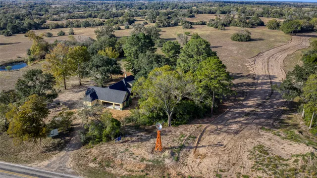 an aerial view of a house with a yard